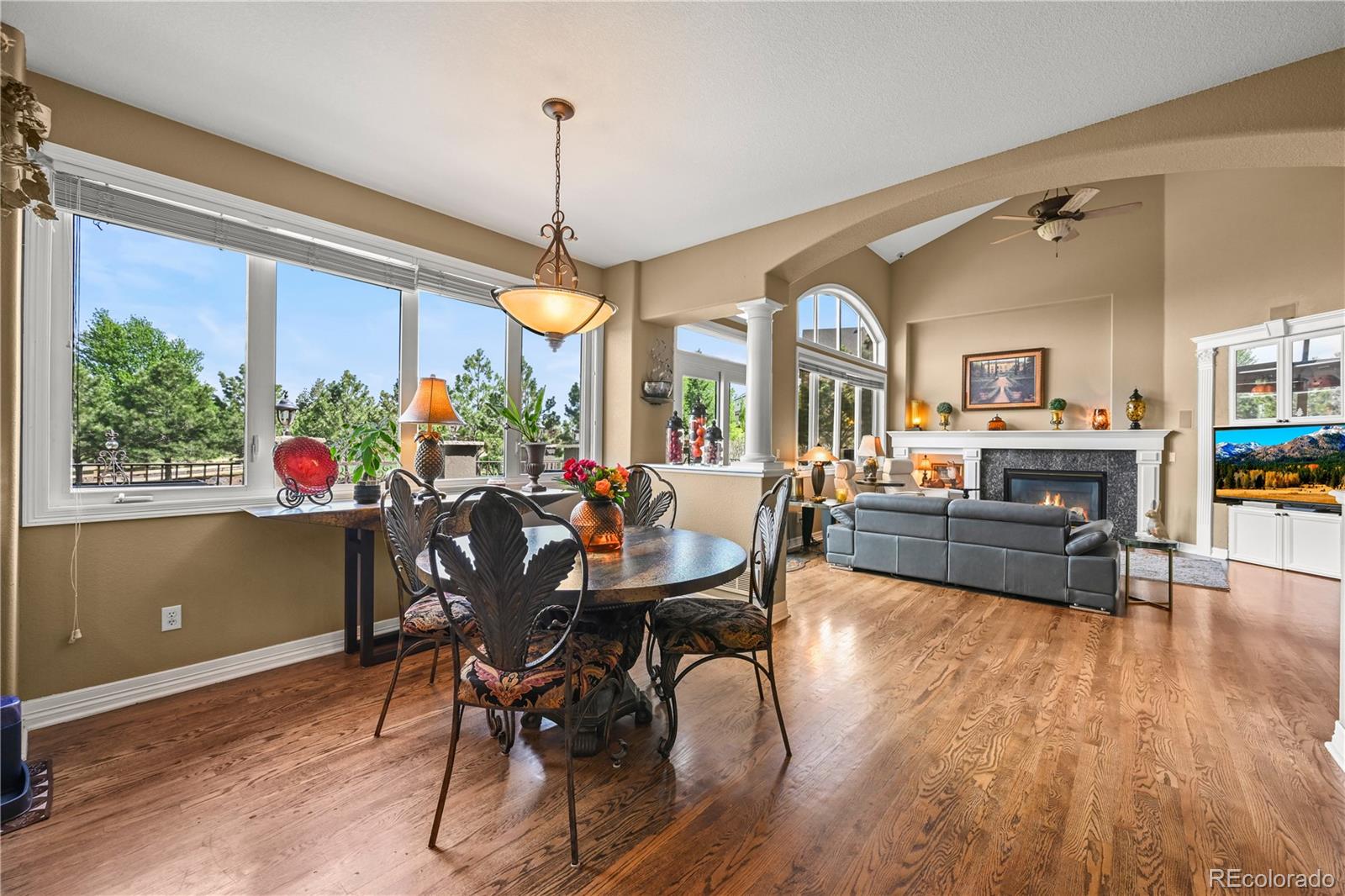 8518 High Ridge Court Castle Pines, CO 80108 - Photo 13 of 29 a view of a dining room with furniture window and wooden floor