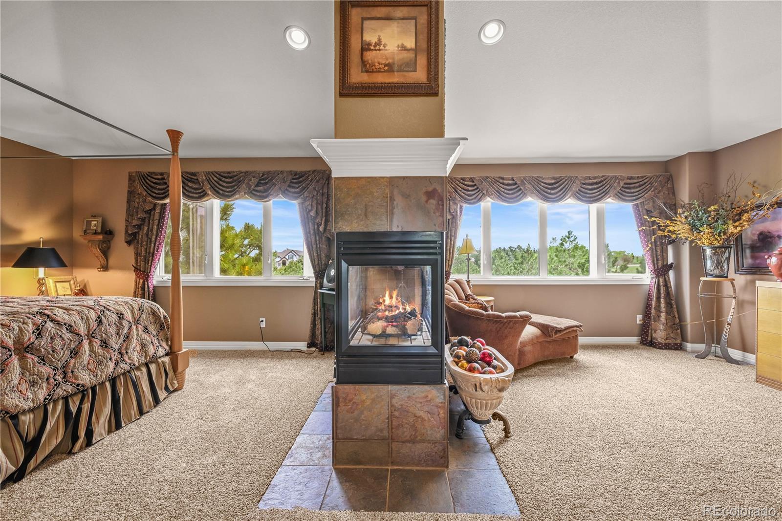 8518 High Ridge Court Castle Pines, CO 80108 - Photo 17 of 29 a bedroom with furniture and a fireplace