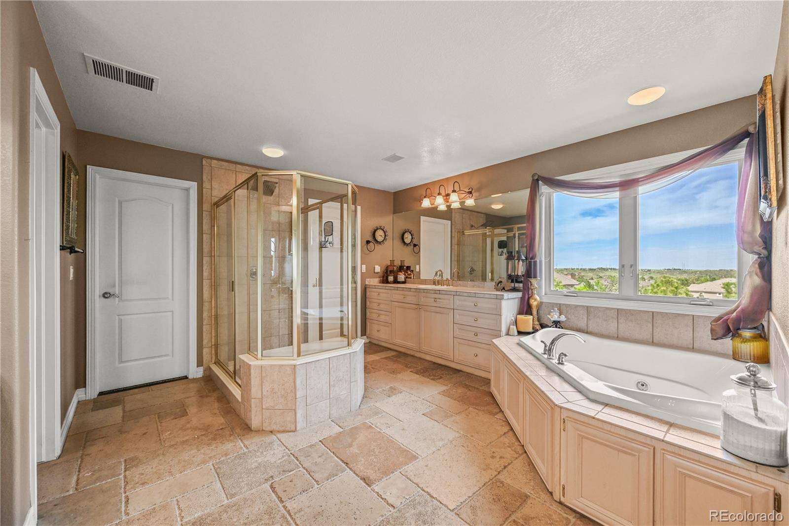 8518 High Ridge Court Castle Pines, CO 80108 - Photo 19 of 29 a bathroom with a tub a sink and mirror