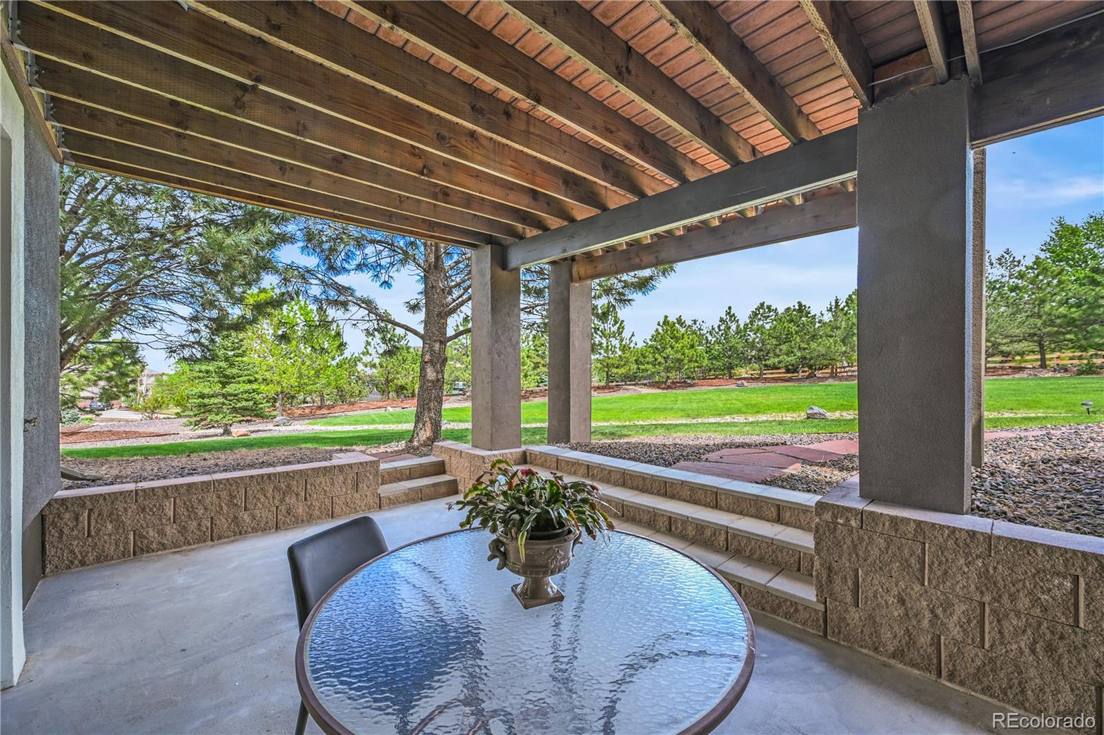 8518 High Ridge Court Castle Pines, CO 80108 - Photo 26 of 29 a view of a porch with furniture and a backyard
