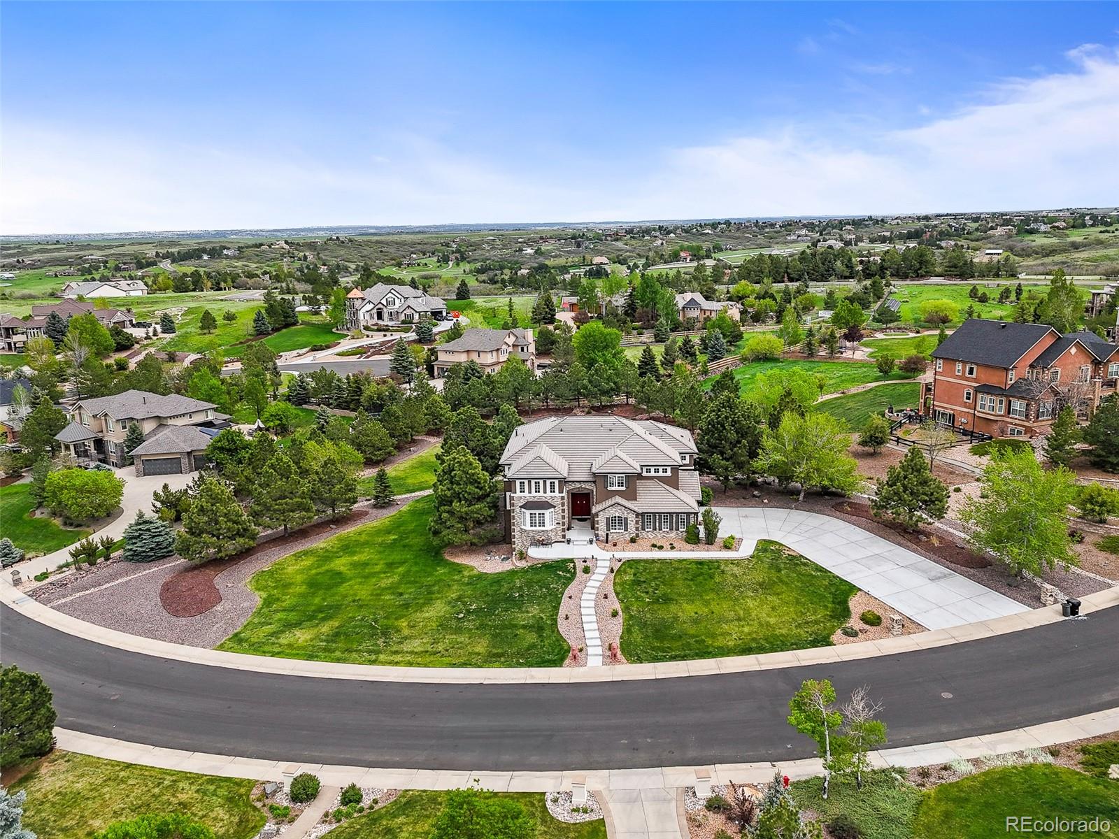 8518 High Ridge Court Castle Pines, CO 80108 - Photo 3 of 29 an aerial view of a house with garden space and street view