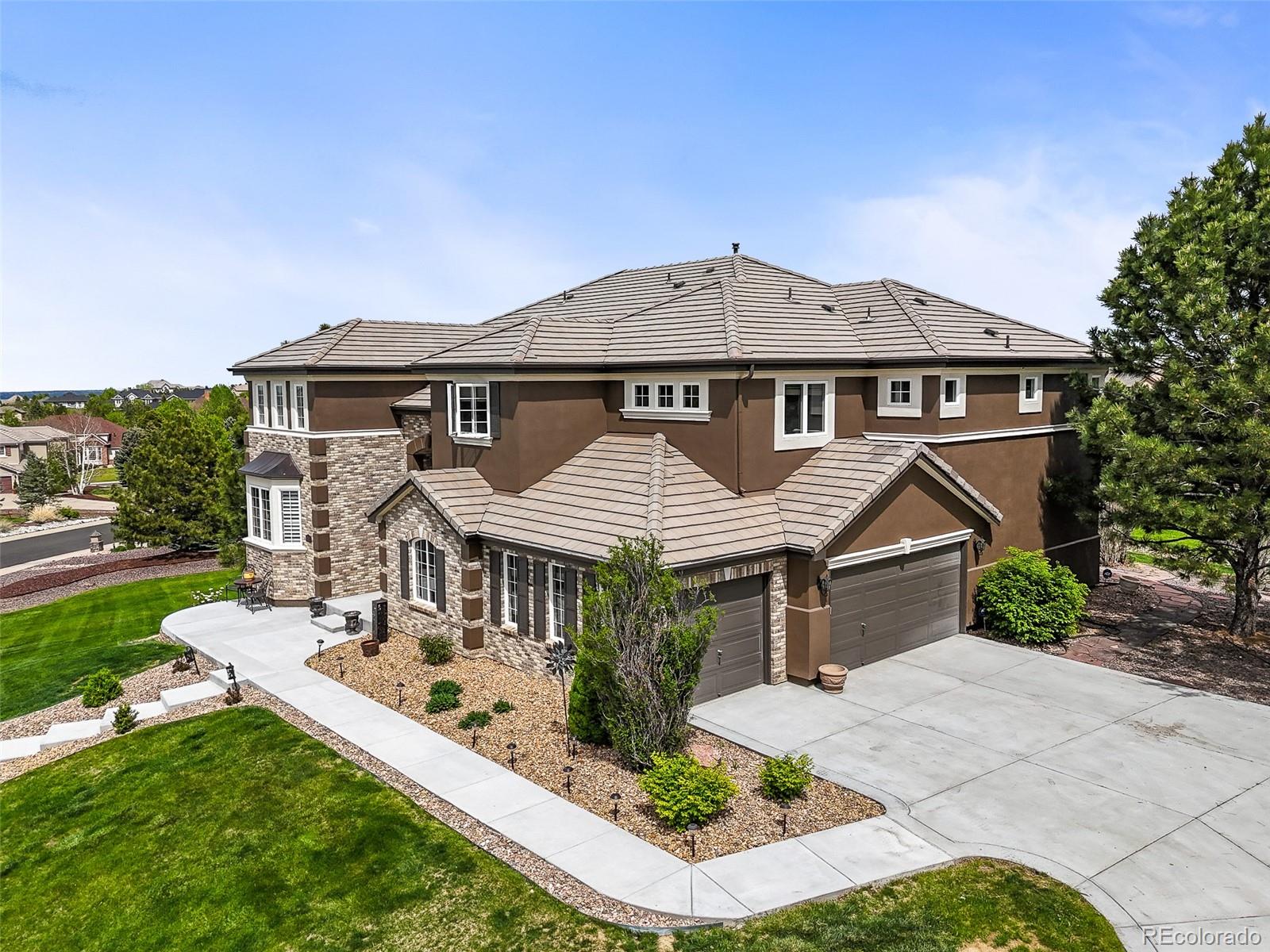 8518 High Ridge Court Castle Pines, CO 80108 - Photo 4 of 29 front view of a house with a yard