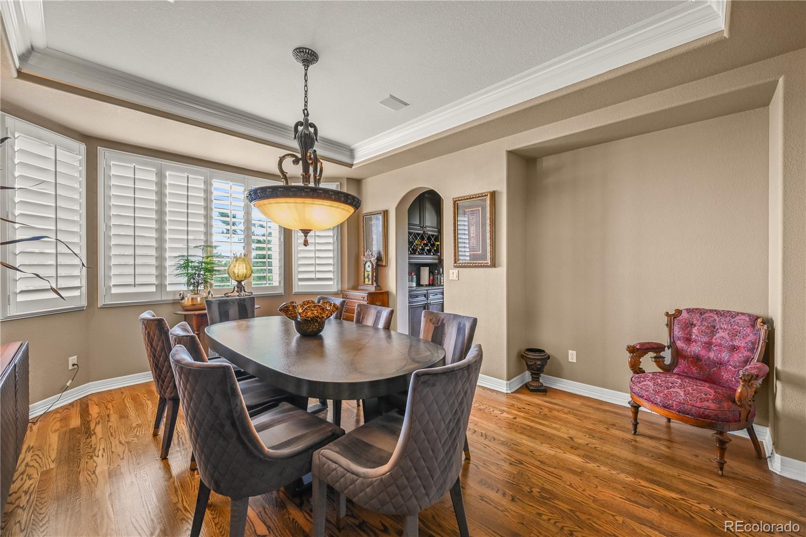 8518 High Ridge Court Castle Pines, CO 80108 - Photo 8 of 29 a dining room with furniture a chandelier and wooden floor