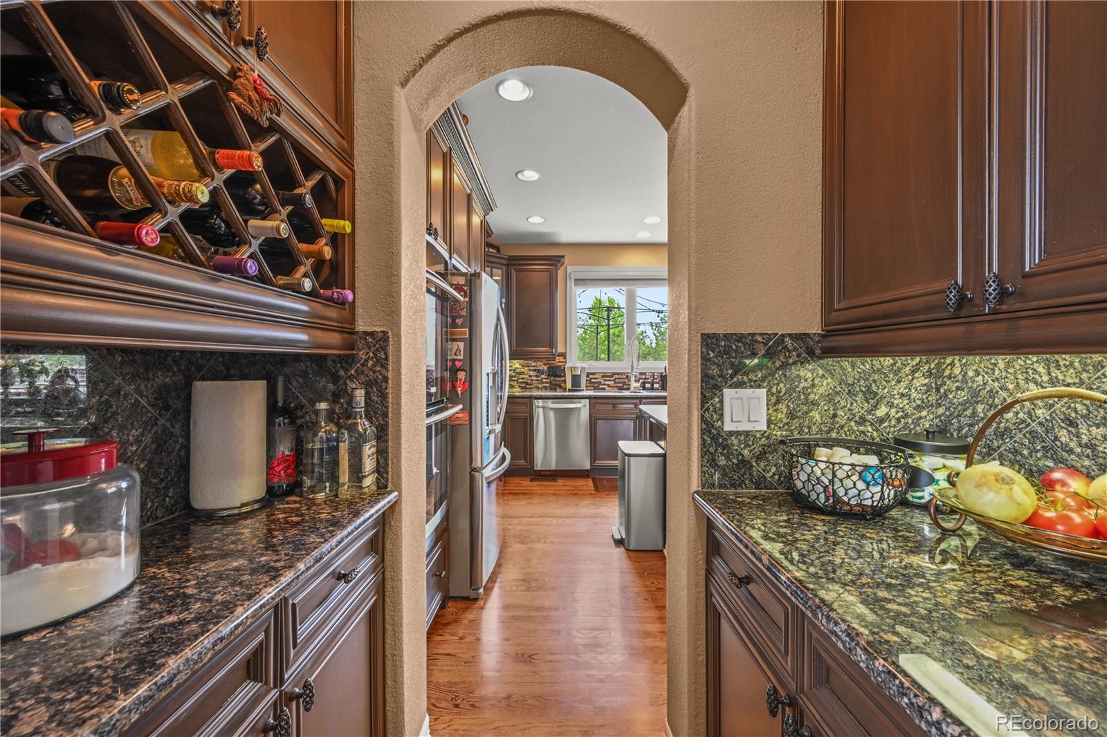 8518 High Ridge Court Castle Pines, CO 80108 - Photo 9 of 29 a kitchen with stainless steel appliances granite countertop a stove and cabinets