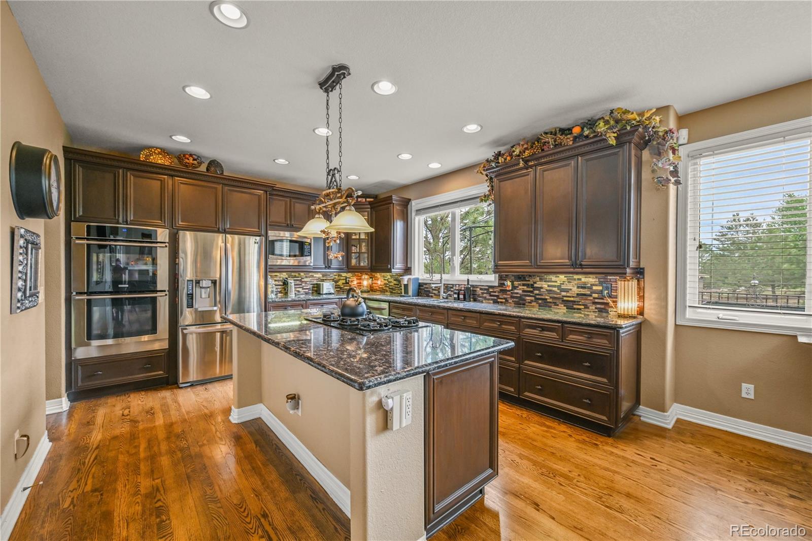 8518 High Ridge Court Castle Pines, CO 80108 - Photo 10 of 29 a kitchen with stainless steel appliances granite countertop a sink stove and refrigerator