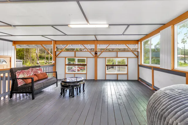 a view of house with backyard outdoor seating and green space