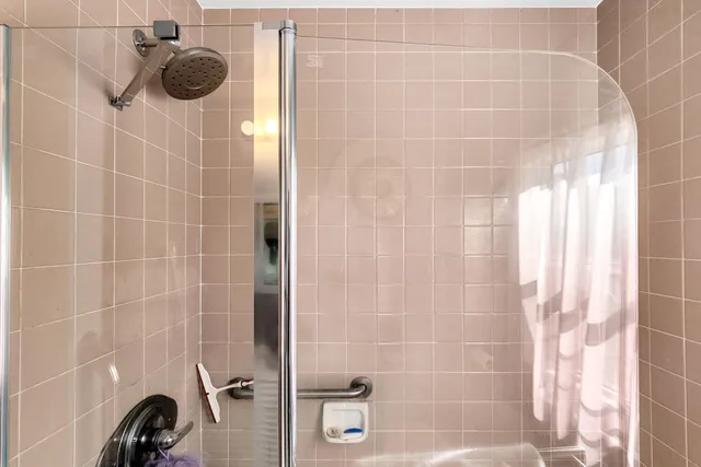 a bedroom with a large bed and a large window with outer view