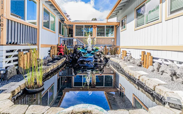 a view of a chairs and table in the balcony