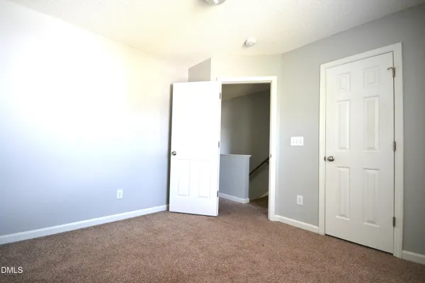 an empty room with an entrance to other room