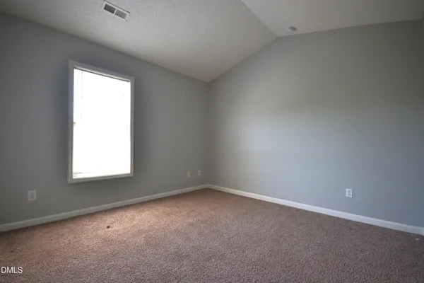 a view of a wooden deck and a yard