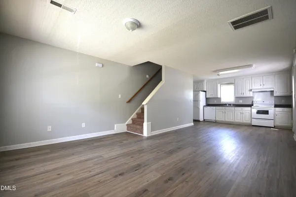 a view of a kitchen with wooden floor and a kitchen