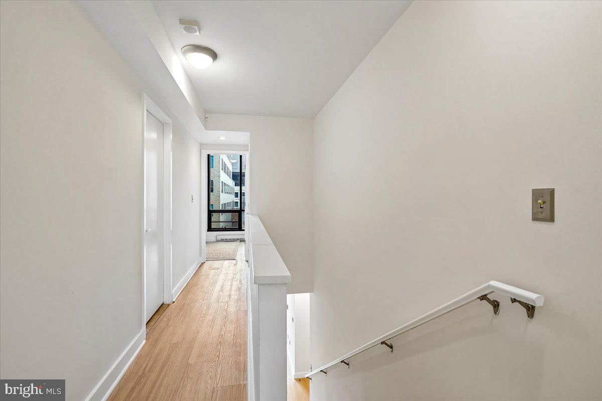 912 F Street Northwest, Unit 709 Washington, DC 20004 - Photo 12 of 28 a view of a hallway with wooden floor and closet