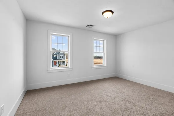 an empty room with windows and closet