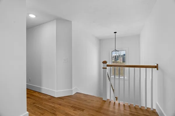 a view of hallway with wooden floor