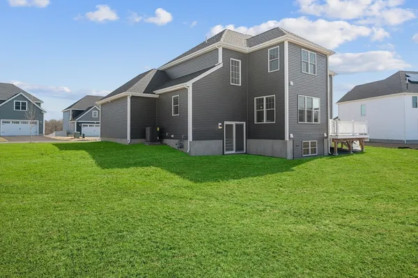 a view of a house with a yard and sitting area