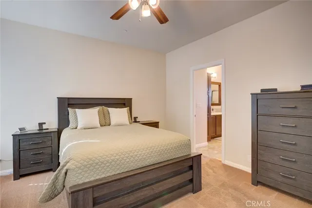 a bedroom with bed and a chandelier