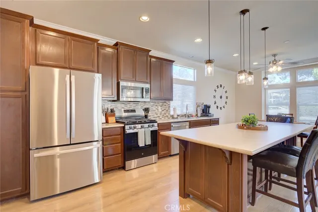 a kitchen with a refrigerator a stove and white cabinets