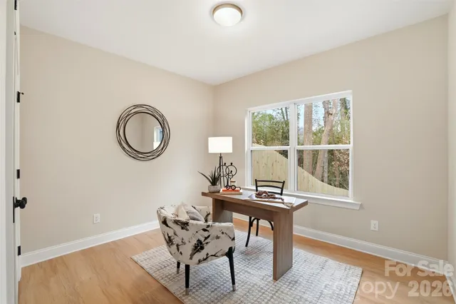 a workspace with wooden floor and a window