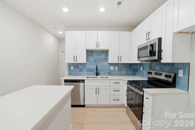 a kitchen with a sink stove and microwave