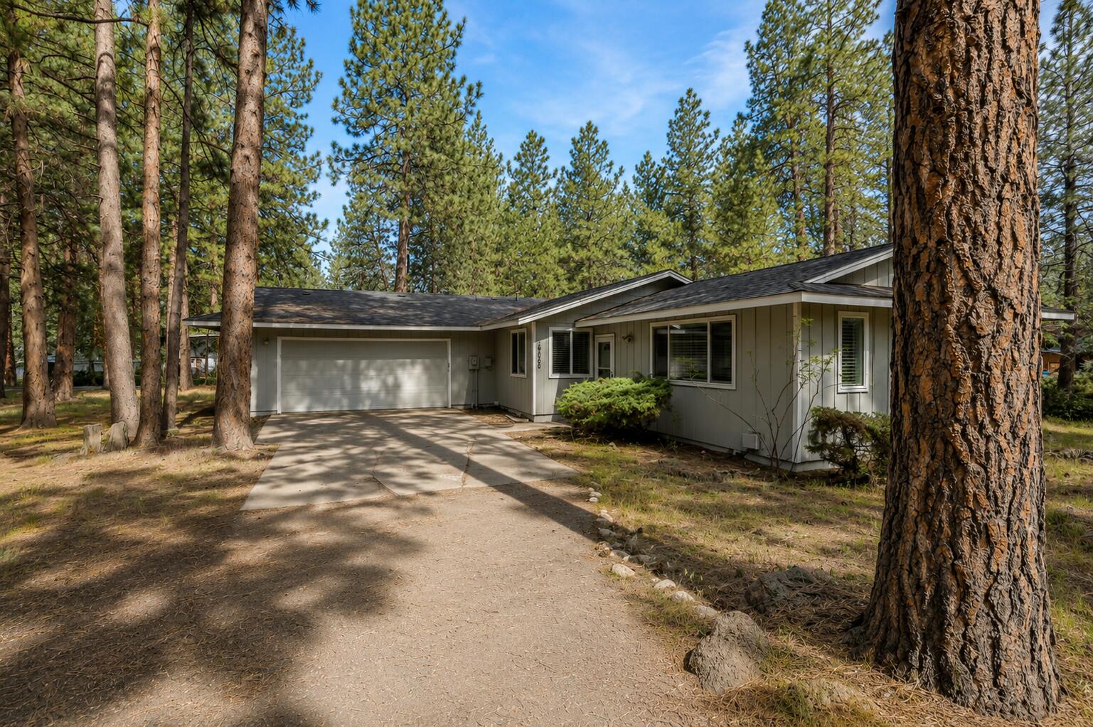 19968 Double Tree Court Bend, OR 97702 - Photo 26 of 28 a view of a house with backyard and trees