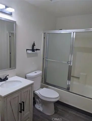 a bathroom with a toilet a sink and shower