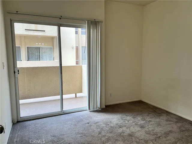 an empty room with sliding glass door