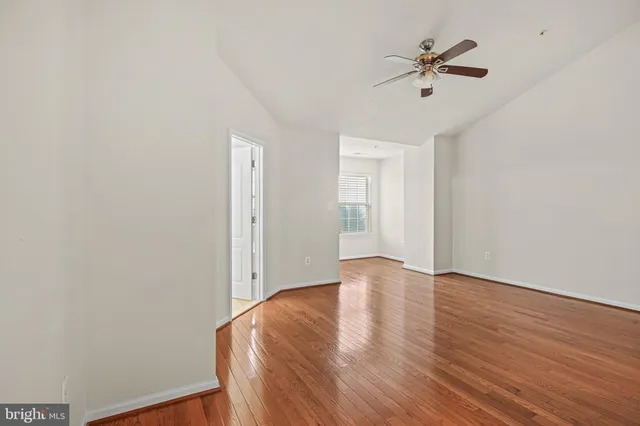a view of room with hardwood floor and ceiling fan