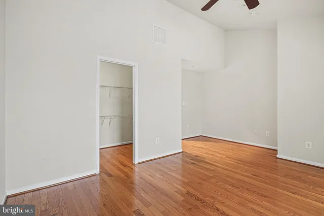 a view of an empty room with wooden floor