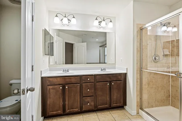 a spacious bathroom with a granite countertop sink and a mirror