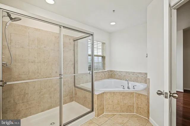 a bathroom with a tub and shower