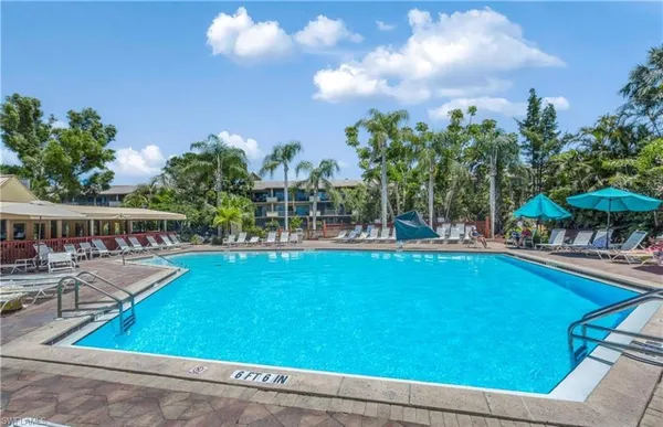 a view of swimming pool with outdoor seating and plants