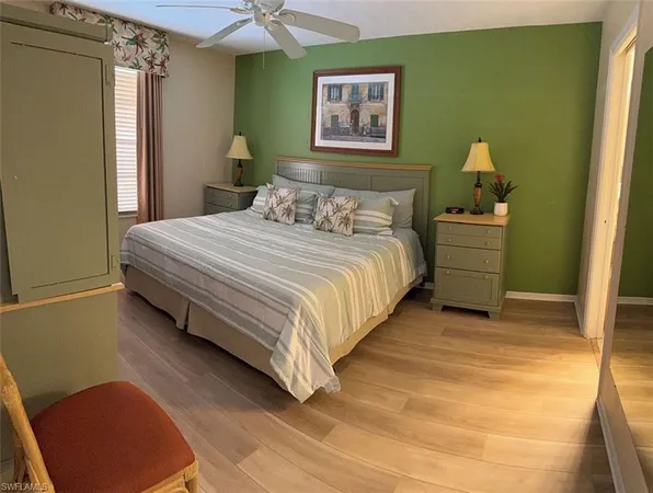 a bedroom with a bed and a painting on the wall