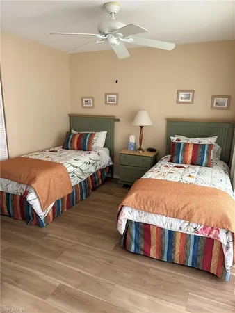 a bedroom with bed and a chandelier
