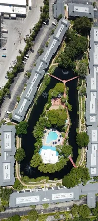 an aerial view of a house with a yard basket ball court and outdoor seating