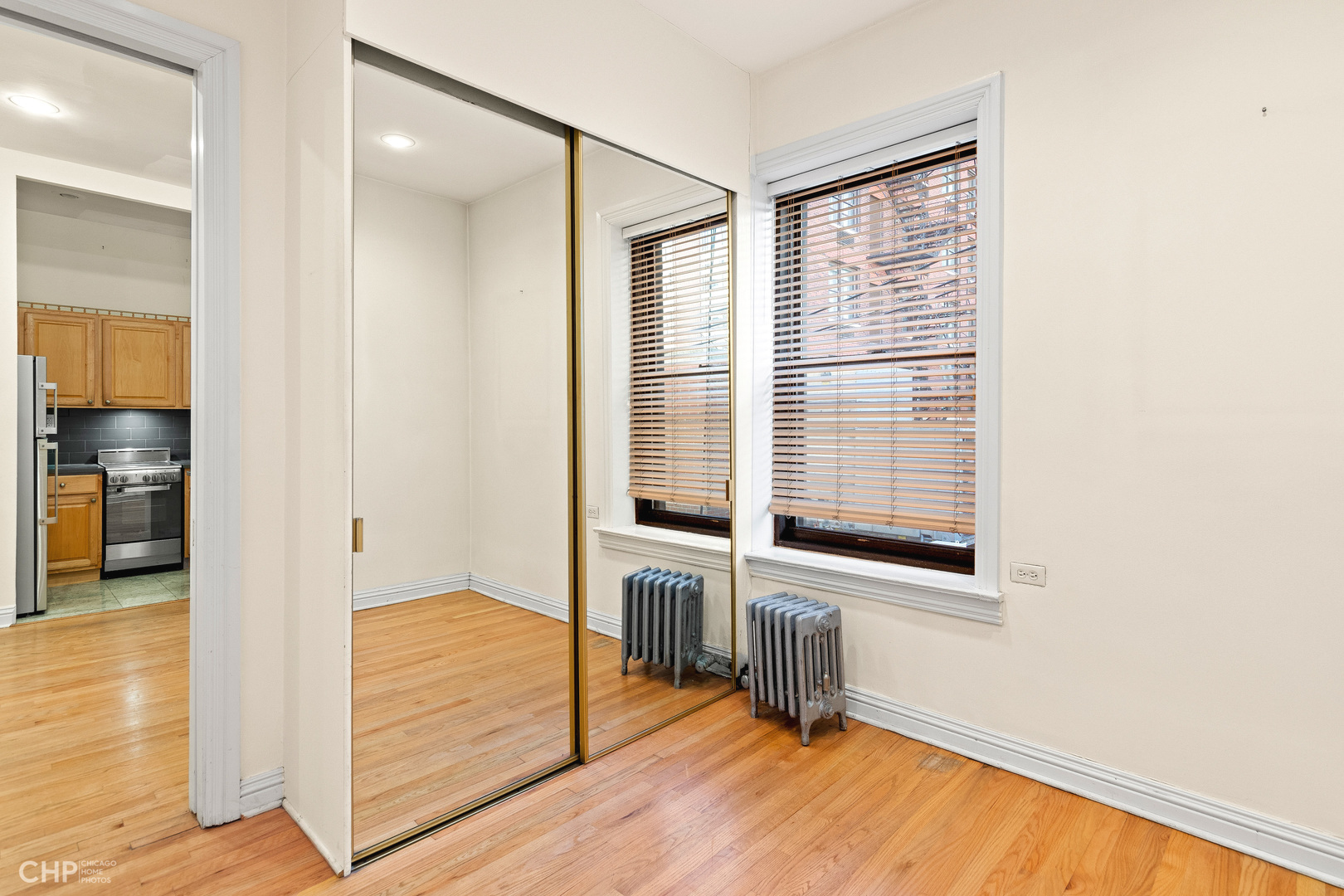 20 East Goethe Street, Unit 306 Chicago, IL 60610 - Photo 11 of 14 a view of an empty room with wooden floor and a window