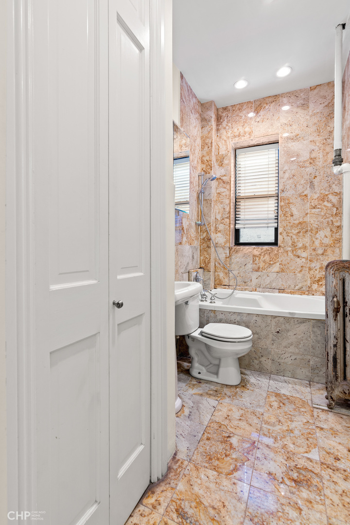 20 East Goethe Street, Unit 306 Chicago, IL 60610 - Photo 12 of 14 a bathroom with a toilet a sink and bathtub