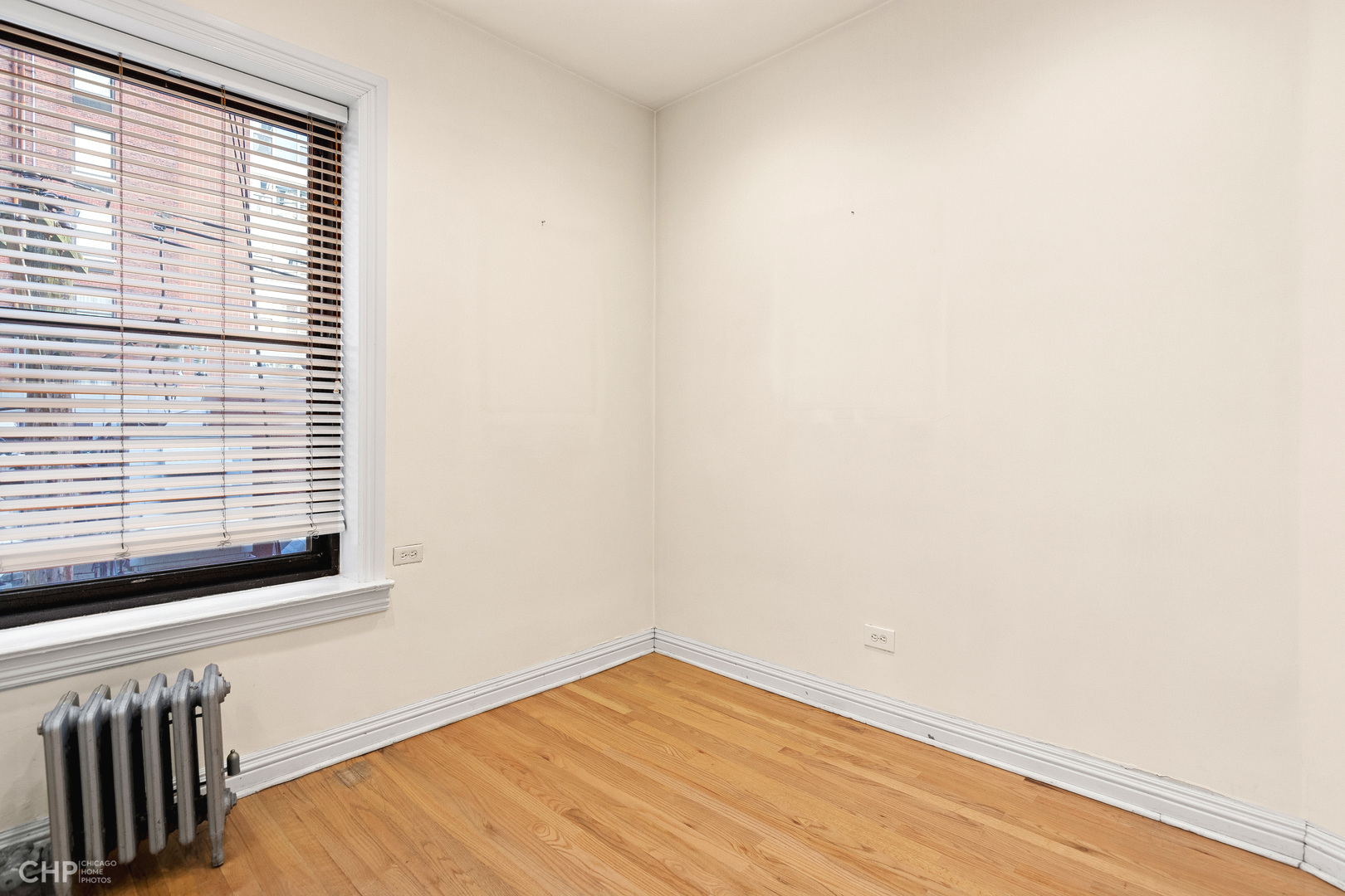 20 East Goethe Street, Unit 306 Chicago, IL 60610 - Photo 9 of 14 a view of an empty room with wooden floor and a window