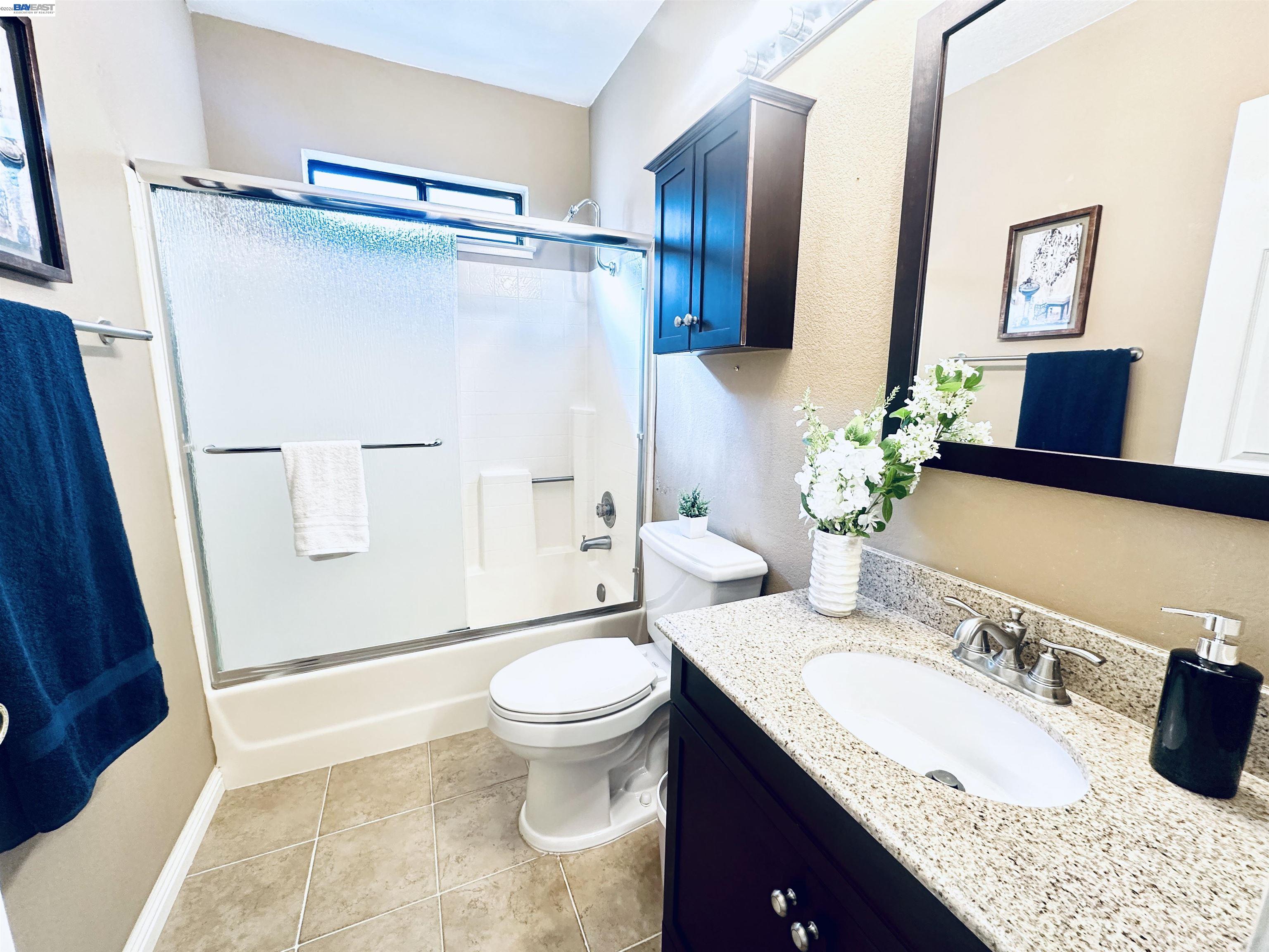 320 North Villa Way Walnut Creek, CA 94595 - Photo 19 of 36 a bathroom with a granite countertop sink toilet and shower