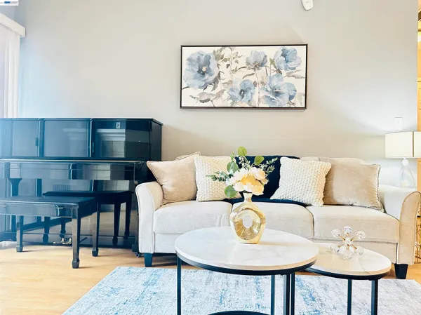 a living room with furniture a rug and a large window