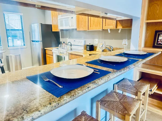 a kitchen with furniture and a large window