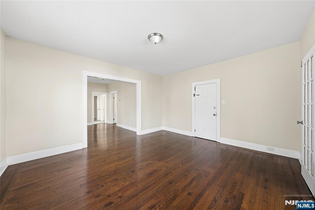 50 Unity Avenue Newark, NJ 07106 - Photo 12 of 42 a view of an empty room with wooden floor and a window