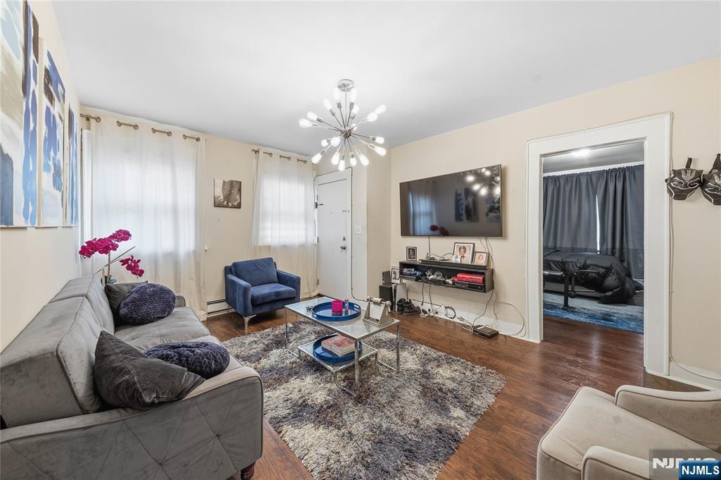 50 Unity Avenue Newark, NJ 07106 - Photo 15 of 42 a living room with furniture and a flat screen tv