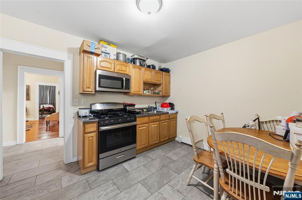 50 Unity Avenue Newark, NJ 07106 - Photo 20 of 42 a kitchen with stainless steel appliances granite countertop a stove and a sink