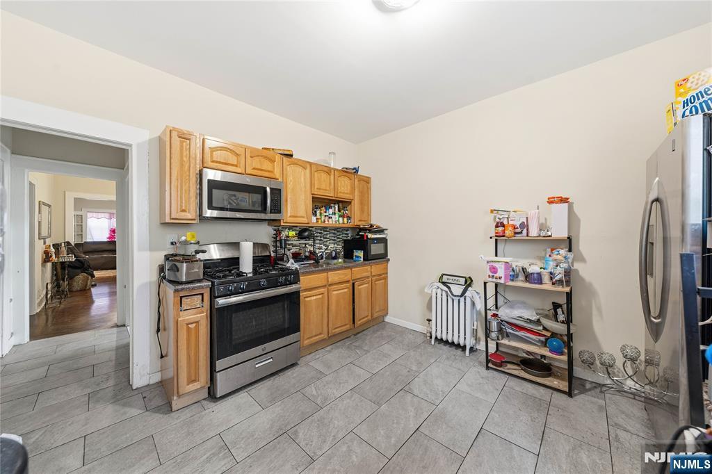 50 Unity Avenue Newark, NJ 07106 - Photo 29 of 42 a kitchen with stainless steel appliances a stove and a refrigerator