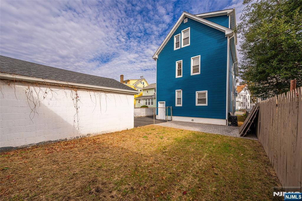 50 Unity Avenue Newark, NJ 07106 - Photo 36 of 42 a front view of a house with a yard and garage
