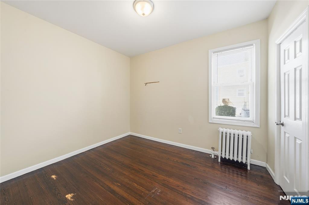 50 Unity Avenue Newark, NJ 07106 - Photo 4 of 42 an empty room with wooden floor and windows