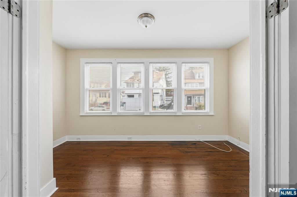 50 Unity Avenue Newark, NJ 07106 - Photo 6 of 42 a view of empty room with wooden floor and fan