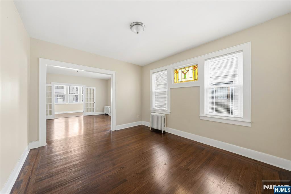 50 Unity Avenue Newark, NJ 07106 - Photo 7 of 42 a view of an empty room with wooden floor and a window