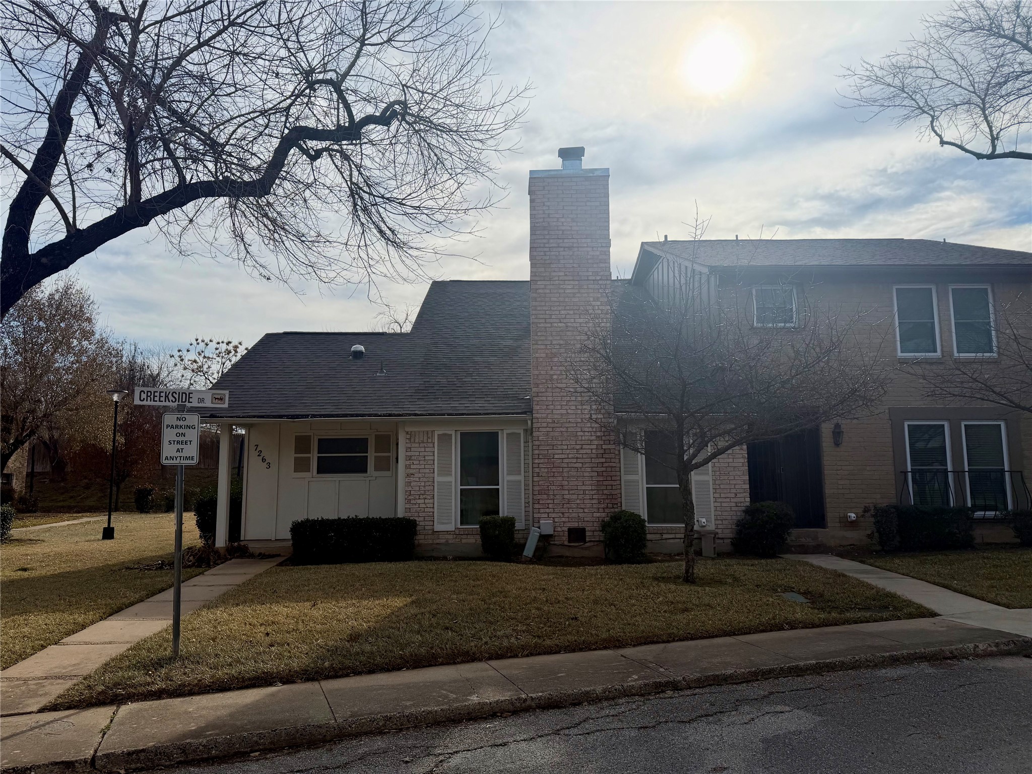7263 Creekside Drive Austin, TX 78752 - Photo 1 of 1 a front view of a house with a yard