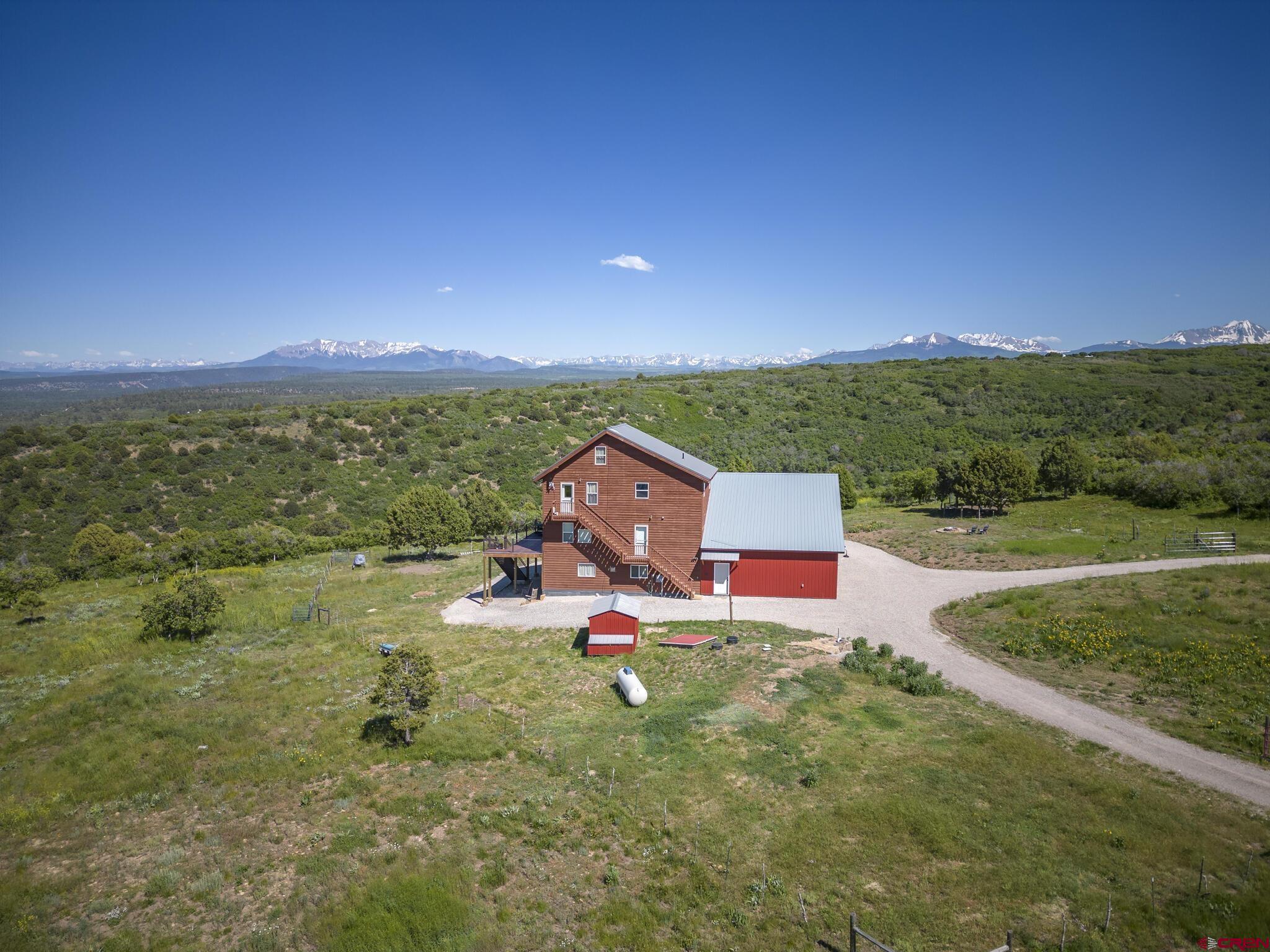 an aerial view of a house with a yard